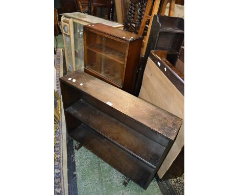 A 1930's oak glazed bookcase; a 1970's ornate China display cabinet; a reproduction display cabinet; an oak three shelf bookc