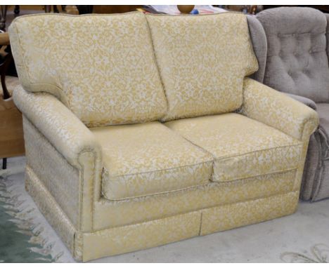 A two seater sofa bed in tones of yellow