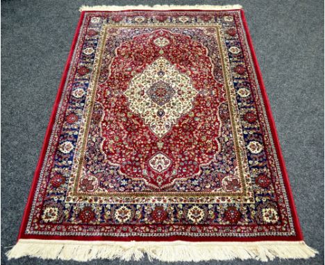 A red ground Kashmir rug, traditional medallion design. 170cm x 120cm