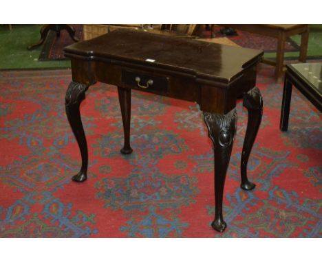 A Chippendale style card table, fold over top opening to green baize playing surface and cups, single drawer to frieze, cabri