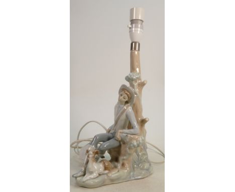 Lladro figural lamp base boy &amp; dog seated by tree: Height 31cm. 