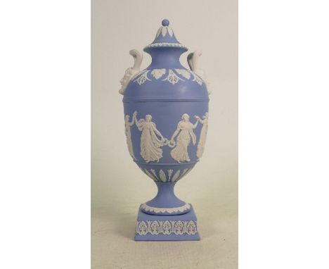 A Wedgwood two handled light blue dip Jasperware urn &amp; cover: Decorated with dancing hours ladies, dated 1964, height 28c