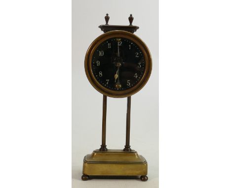 Watson Clock Company Kee-less gravity clock in brass with visible escapement: The movement falling down hexagonal pillars, on