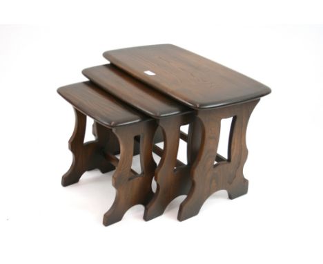 A nest of three dark Ercol occasional tables