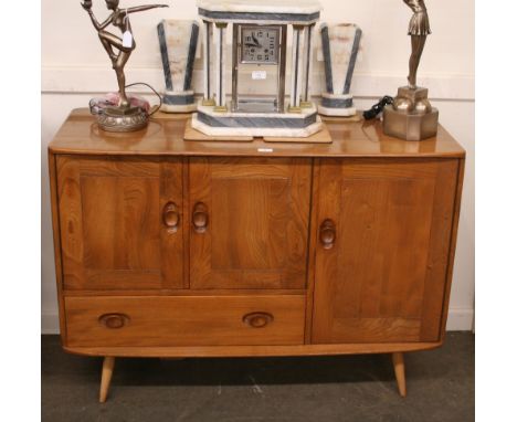 A light Ercol sideboard fitted  two door cupboard above single drawer beside further cupboard door with internal cutlery tray