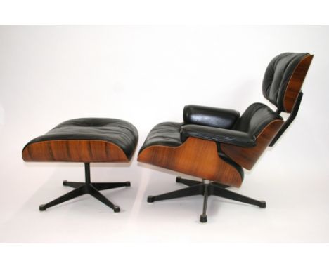 A design by Charles and Ray Eames for Herman Miller, a rosewood veneered and black leather button down upholstered lounge cha