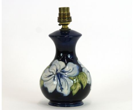 A Moorcroft pottery 'Hibiscus' table lamp, decorated with tube lined pale blue Hibiscus on deep blue ground, stamped to base,