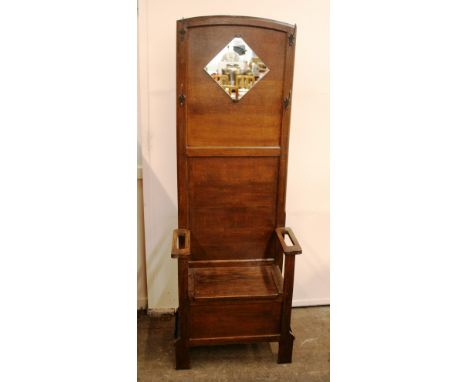 An oak and mirrored hall stand with attached coat hooks and under seat storage flanked by stick stands, 177cm high, 63cm wide
