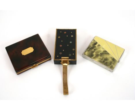 A 1940s Parklane carry all, inset with coloured stones, 11cm; an Art Deco Princess combination compact, 9.5cm and a Parco of 