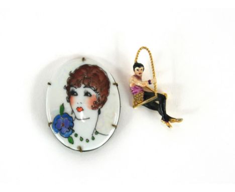 An enamel decorated brooch in the form of a trapeze artist and an oval porcelain brooch decorated with portrait of an Art Dec