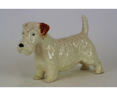 A Beswick style model of a dog marked 'Made In England', 14.5cm high