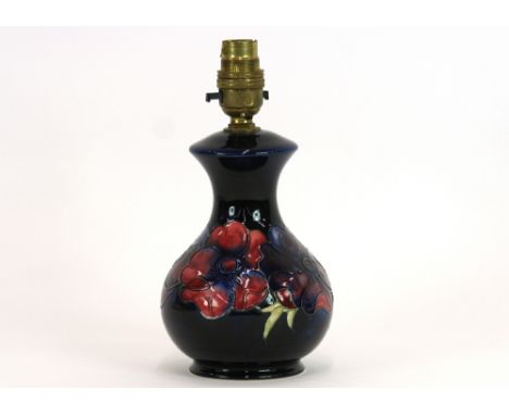 A Moorcroft pottery 'Anemone' table lamp, decorated with tube lined flowers on deep blue ground, stamped to base, Moorcroft, 