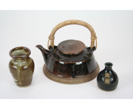 A Studio pottery teapot with Tenmoku glaze and cane swing handle, impress mark to base; an Aylesford vase and a miniature Stu