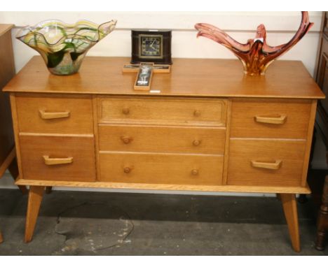 A G plan style light oak dressing chest fitted three long and four short drawers, 73cm high, 124cm wide, 48cm deep