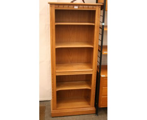 A light Ercol bookcase, 156cm high, 64cm wide, 34cm deep