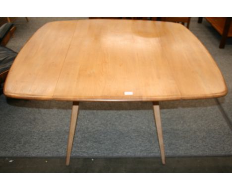 A light Ercol drop leaf dining table, 72cm high, 123cm x 112cm extended