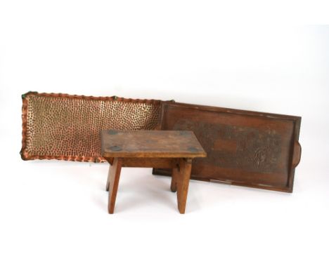 An Arts and Crafts copper tray; a carved wooden tray decorated with flowers and leaves and a small oak and inlaid folding sto