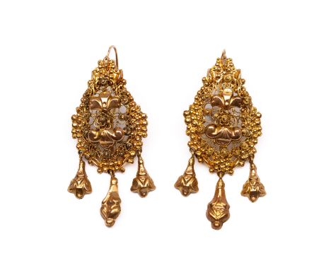 Een paar 14 kt. gouden druppelvormige oorhangers, midden 19e eeuw. Gedecoreerd met cannetille en repoussé. De onderzijde elk 