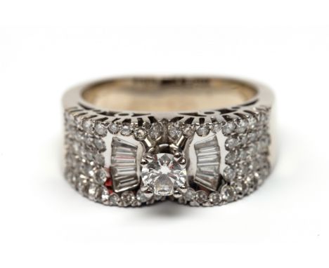 18 kt. Witgouden bandring, centraal bezet met een briljant geslepen diamant van ca. 0.30 ct., met aan weerszijden vijf tapere