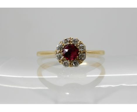 An 18ct gold ruby and diamond cluster ring, head size 7mm, finger size M, weight 2.2gms Condition Report: Available upon requ