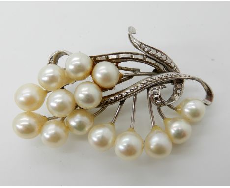 A 14ct white gold pearl set brooch, 5.5cm x 3.6cm, weight 12.6gms Condition Report: Available upon request