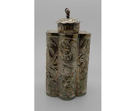 A Burmese white metal tea caddy, unidentified marks on the base, the cylindrical lobed body embossed with a building and vari