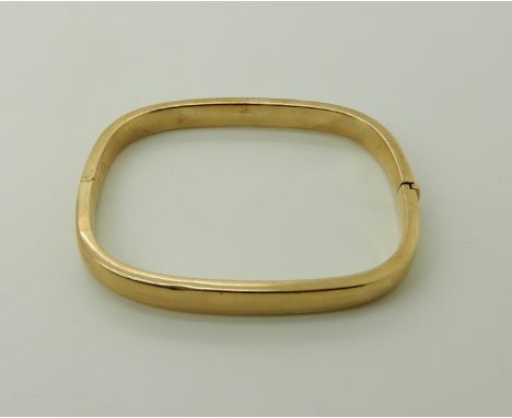 A 9ct gold bangle internal dimensions 6cm x 5.1cm, weight 13.1gms Condition Report: Available upon request