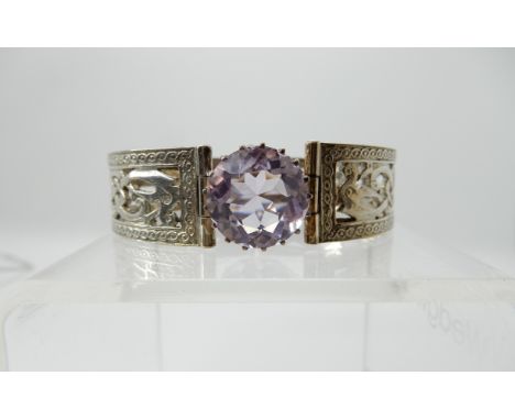 A silver Hamish Dawson - Bowman knotwork dragon bangle set with an amethyst Condition Report: Not available for this lot