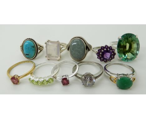 A collection of silver and white metal rings to include, mermaid mystic topaz, ruby, peridot etc Condition Report: Not availa