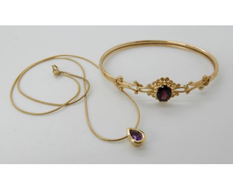 A 9ct gold garnet bangle, and a 9ct amethyst pendant and chain length 42cm approx, weight for both item together 9.4gms Condi