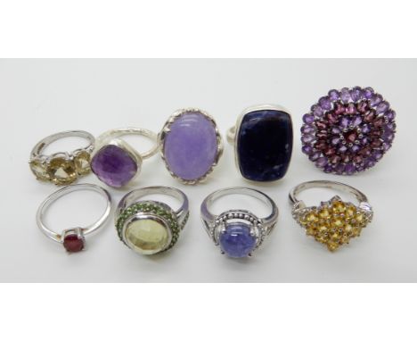 A collection of silver and white metal rings to include, lilac hardstone, amethyst, citrine etc Condition Report: Not availab