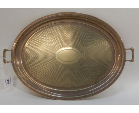 A silver plated twin handled serving tray of oval form with engine turned decoration, 46cm across the handles Condition Repor