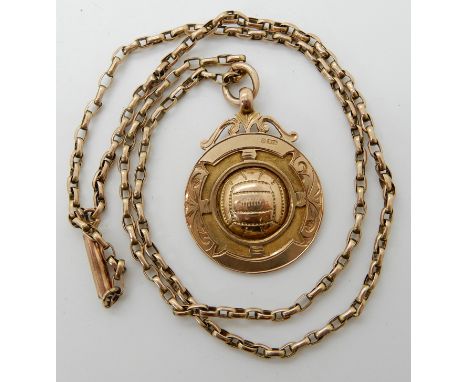 A 9ct gold football medallion with a 9ct vintage chain, length of chain 48cm, weight 11gms Condition Report: Available upon r