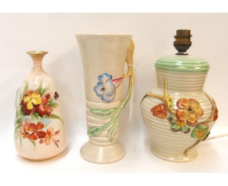 A Clarice Cliff moulded flower lamp base and vase and a nautilus porcelain vase Condition Report: Nautilus is cracked.Clarice