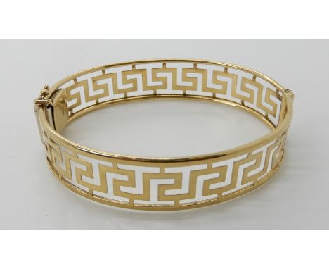 A 9ct gold Greek key pattern bangle, inner dimensions 6.5cm x 5.4cm, weight 14.5gms Condition Report: Available upon request