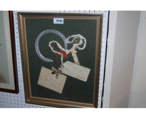 A framed display with horseshoe with note reading This is an identical plate believed to have worn by The Tetrarch in the Cha