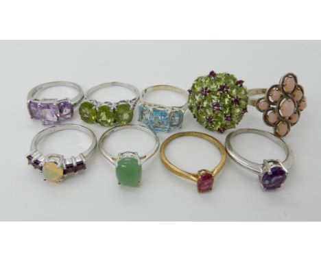 A collection of silver and white metal rings to include, peridot, amethyst, opal etc Condition Report: Not available for this