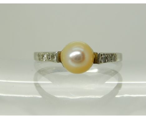A white metal diamond and pearl set ring, size N, weight 2.5gms Condition Report: Available upon request