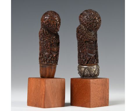 Northeast-Java/ Madura, two wooden kris hilts, one with curly hairdo at the back and carved as an abstracted floral ancestor 