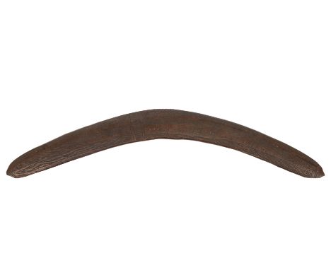 Australia, Aboriginal, boomerang, on one side with a notched pattern, the reverse with grooved pattern. L. 56,6 cm. Provenanc