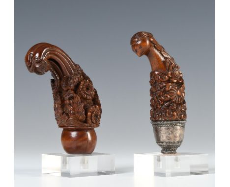 Madura, two wooden kris hilts, one with silver selut showing a cockatoo on top of floral motifs and emblems, the other with a