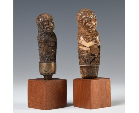 North-Java, two deer horn kris hilts, both shaped as a raksasa with long flowing hair and floral details, one with a silvered