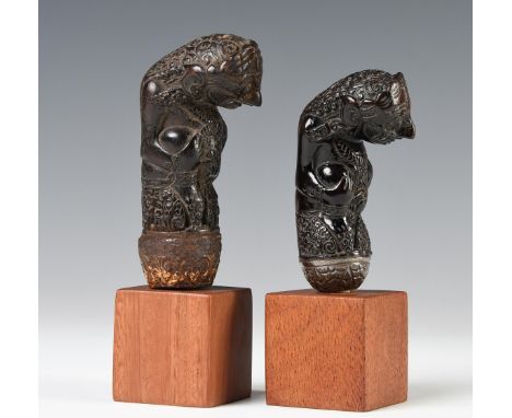 North West Java, Cirebon, two wooden kris hilts, both representing ancestor or raksasa figures, hands touching the knees and 