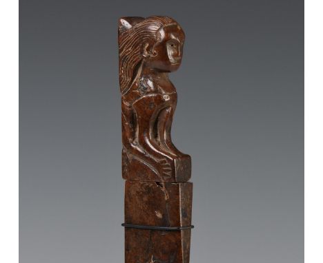 East-Java, old knife, the blade showing an old and etched pamor,  wooden hilt showing a sphinx-like figure, wooden scabbard. 