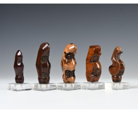 Central-Java, Surakarta, five wooden kris handles, all depicting young shoots on a tree trunk and  resembling abstracted pana