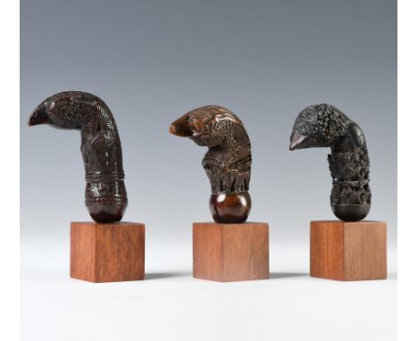 South-Sumatra, two wooden kris hilts and a Minangkabau, wooden kris hilt, 19th century, the first hilt shaped as an ancestor 
