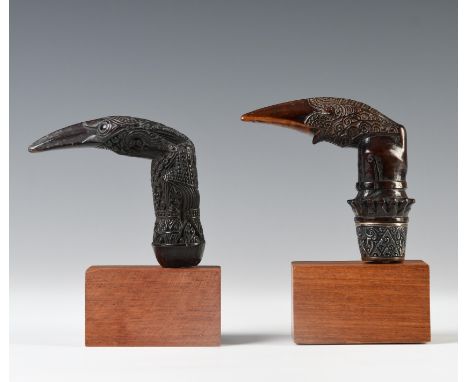 Sumatra, Lampung, two wooden kris hilts, one with a protruding lower lip and embossed silver selut, the other carved with lon