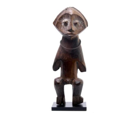 D.R. Congo, Zande, a wooden figure, with a hart shaped face, iron neck ring and white pigments.  h. 29 cm. Provenance, Hans W