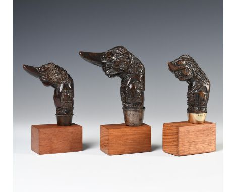 North West Java, Cirebon, three wooden hilts, shaped as long-nosed ancestor figures, all with silver selut. h. 12,5; 10 and 1