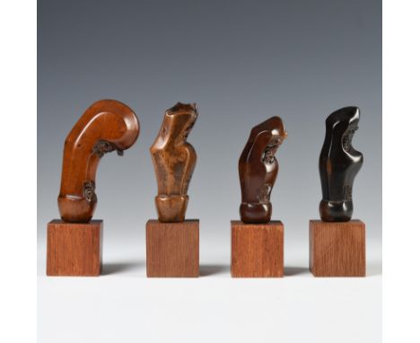 Java, Surakarta, four wooden kris handles, one shaped as a young shoot on a trunk, well-carved details, the other three carve
